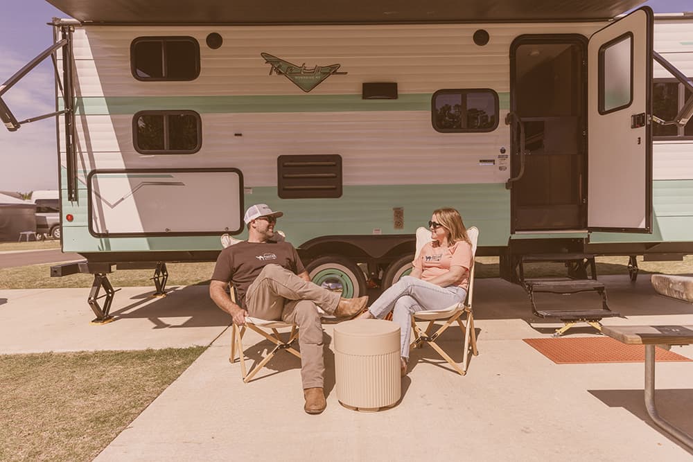 Melinda and Daniel Thompson relaxing by their Riverside Retro camper